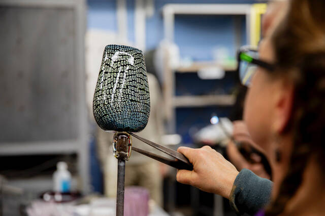 Katrina Hude shapes a piece of glass. (Photo provided)