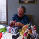 Photo by Luisa Loi
June Zacharia prepares gifts for the Holiday House at her house in Oak Harbor. Every year, she begins to prepare for the event in January, buying gift wrap paper, ribbons and more.