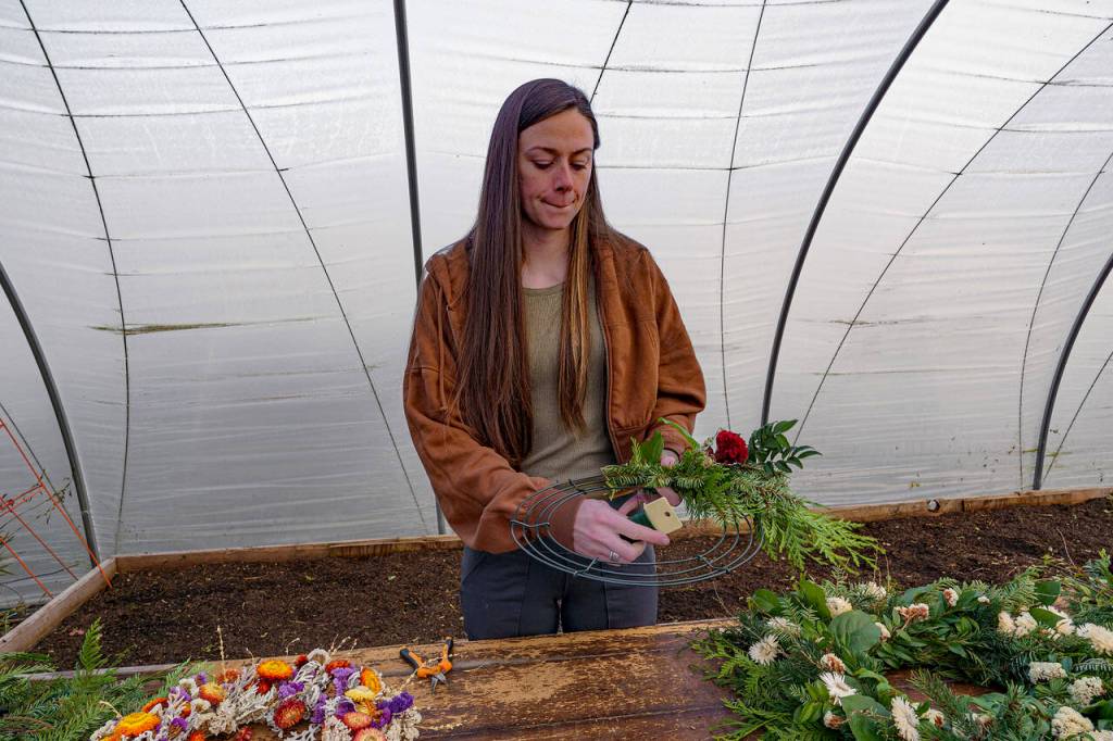 Celosia adds a burst of color to the fresh foliage wreath. (Photo by David Welton)