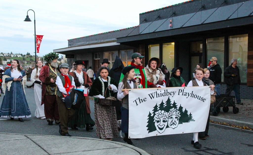 The Whidbey Playhouse joined Santas parade as characters from A Christmas Carol. (Photo by Luisa Loi)