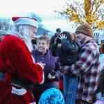 Santa interacts with an excited young fan. (Photo by Luisa Loi)