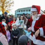 Santa walks around Pioneer Way to greet children. (Photo by Luisa Loi)