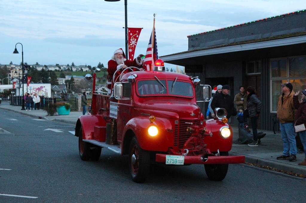 A large crowd cheered as Santa arrived at Dock & Pioneer on board of a shiny red truck. (Photo by Luisa Loi)