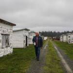 Robert Pelant walks by the former brooder houses for pheasant chicks. (Photo by Luisa Loi)