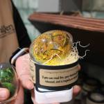 Kristi Uhles from TerraVen holds a hand-painted dragon in a clear resin egg. The egg can be placed on top of a light for an ethereal effect. (Photo by Luisa Loi)