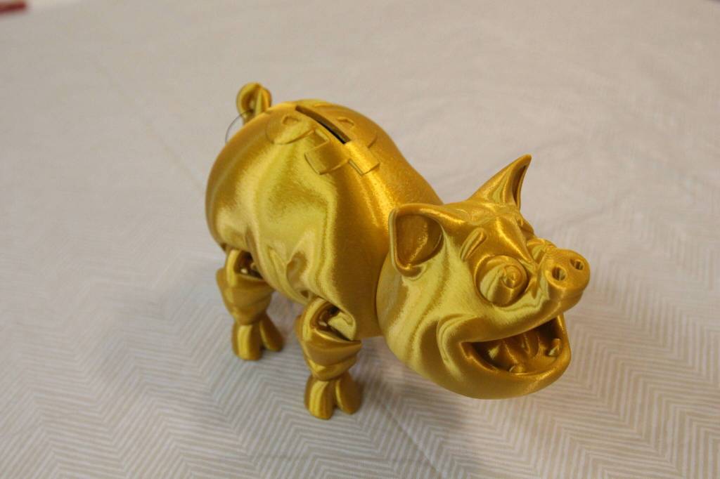 A 3D printed piggy bank, created by Gray Matter and available at Whidbey Island Crafters Market Studios, along with other 3D printed sculptures. (Photo by Luisa Loi)