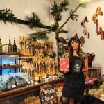 Juliana Uluave-Gould, owner of PNW Vibes, holds Coupeville Coffee Roasters Rustic Pacific Northwest Blend while surrounded by the art provided by her OVERSET FOLLOWS:store. (Photo by Luisa Loi)