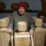 Woodworker Kelly Cameron stands amongst his army of peg people. (Photo by David Welton)