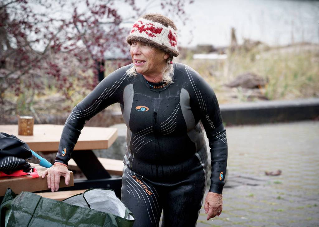 Kate Poss removes gear from her morning swim. (Photo by David Welton)