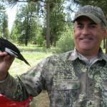 Jeff Kozma holds a white-headed male woodpecker. (Photo provided)