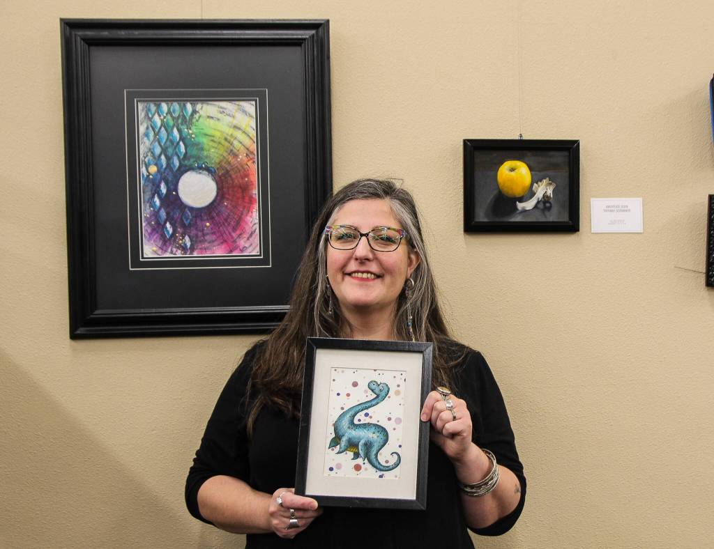 Scribner holds one of her whimsical pieces depicting Nessie. (Photo by Luisa Loi)