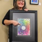 Tiffany Scribner holds Happy Traveler while pointing at the ant. (Photo by Luisa Loi)