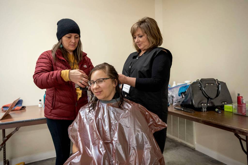 Spring Roehm volunteered to give haircuts to any homeless person that wanted one. When no one else was interested, she and Aimee Tucker groomed a volunteer. (Photo by David Welton)
