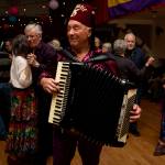 Ken Pickard plays an accordion during a past Mardi Gras party. (Photo by David Welton)