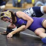 Oak Harbors Julia Gonzales tries to pin her opponent during the subregional tournament that took place last weekend at Oak Harbor High School. Gonzales placed first at 100 pounds and the Wildcats won the tournament. (Photo by John Fisken)