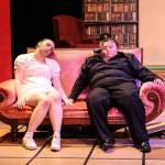 The murdered bodies of the cook (Mara Rotter, at left) and Mr. Boddy (Linndsy Scheer, at right) sit on the couch as the characters scramble to find the culprit. (Photo by Luisa Loi)