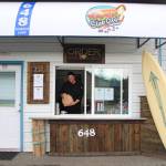 Steve Clarke hands out an order at his new sandwich shop, Slab City Sammies, which he opened after two years of hard work with his with his wife Jean Hamer. (Photo by Luisa Loi)