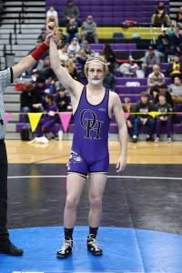 Oak Harbor’s Percie Hatfield has his hand raised in victory after a match during the regional tournament that took place Saturday at Oak Harbor High School. He placed first at 157 pounds and he will advance to the Mat Classic this weekend in Tacoma. Photo by John Fisken.