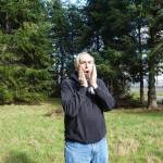Whidbey bigfoot researcher David Ellis emulated a tree knock with his mouth outside Langley (photo by Sam Fletcher)