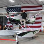 Photo by Luisa Loi
Robert DeLaurentis poses next to his Cessna 182 on aerocet amphibious floats, which is parked inside of the airports main hangar. DeLaurentis also hung a 20-by-30-foot American flag on the wall of the building, which will become an air and car museum and potentially a convention center for community events.