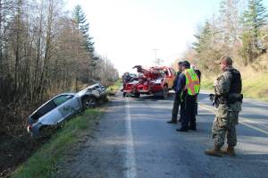 Photo by Luisa Loi
Last Friday, a vehicle rolled down the side of the road and fell about 30 feet onto a dirt road by East Crescent Harbor Road on North Whidbey. The driver was uninjured.
Photo by Luisa Loi
A tow truck pulled out an SUV from the dirt road at the bottom of a 30-foot drop following an accident at East Crescent Harbor Road last Friday.