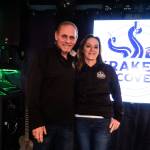 Co-owners Kevin (left) and Megan Collins (right) pose on the Kraken's Cove stage in Oak Harbor.  (Photo by Sam Fletcher)