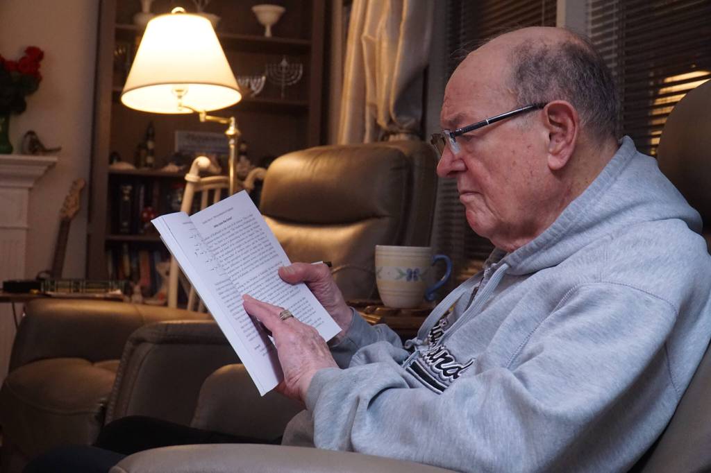 Oak Harbor resident Carl Smith reads at a Kabbalah study session. (Photo by Sam Fletcher)