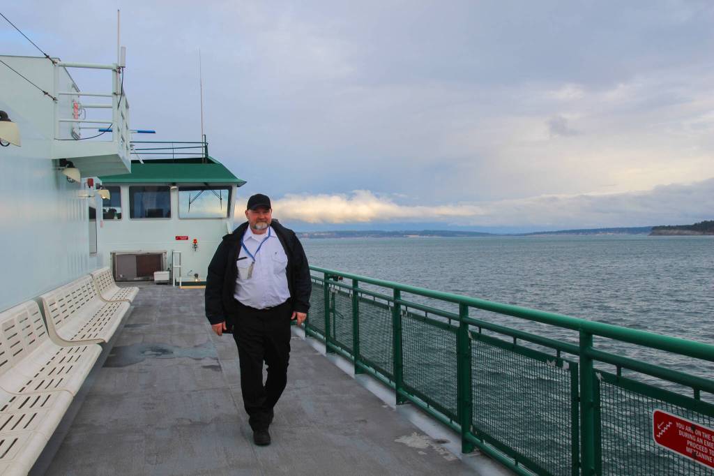 Captain Mark Gripp walks to the other side of the Kennewick to assist with landing in Port Townsend. (Photo by Luisa Loi)