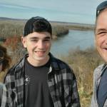 Donovan Davis, the CH-53E helicopter crew chief, smiles with his sister, Madison (left), and father, Greg (right). (Photo courtesy of Greg Davis)