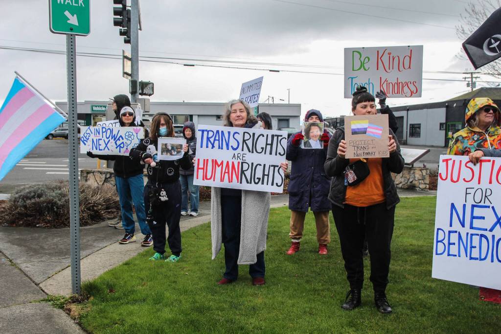 As people held signs and flags in support of trans youths, many drivers honked their cars or revved their engines. (Photo by Luisa Loi)