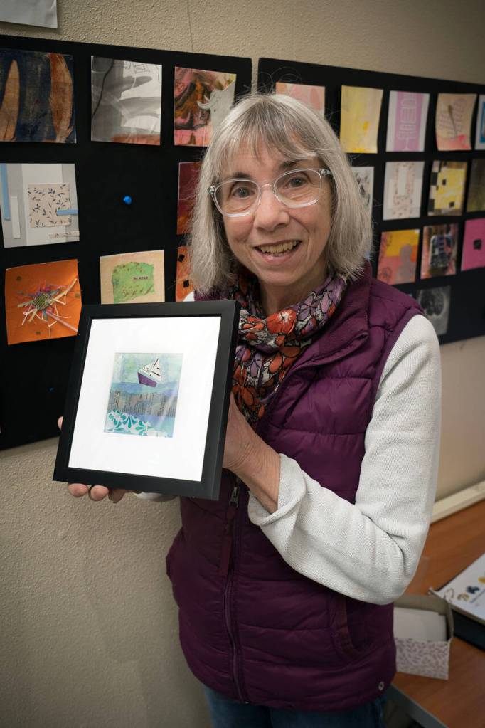Artist Karen Rothboeck holds up a piece of her art that she framed. (Photo by David Welton)