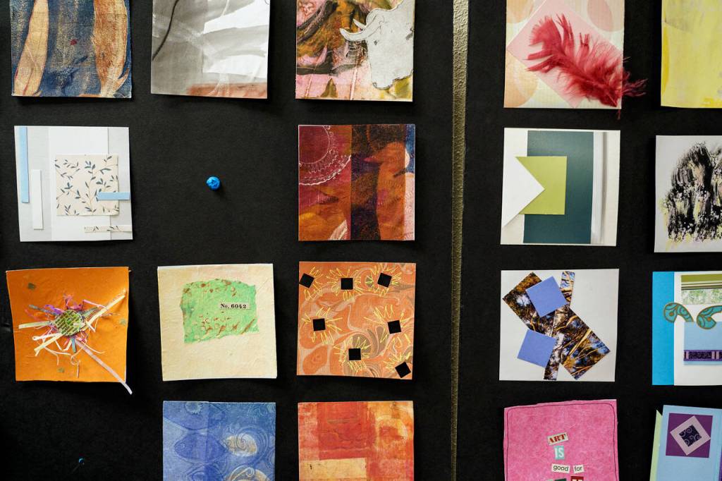 Cyndy Jensen, Karen Rothboeck and Linda Schrock created a total of 200 miniature artworks to display in the Freeland Library for the month of March. Admirers are encouraged to take a piece home with them. (Photo by David Welton)