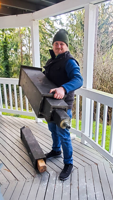 Tom Riecken, whose house was infested by over 1,000 bats, holds a rocket bat box which will house bats in need of a home. (Photo by Luisa Loi)