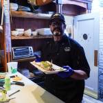 Photo by Sam Fletcher
Sushi chef Claude Johnston shows off the caterpillar roll in Off the Hook.