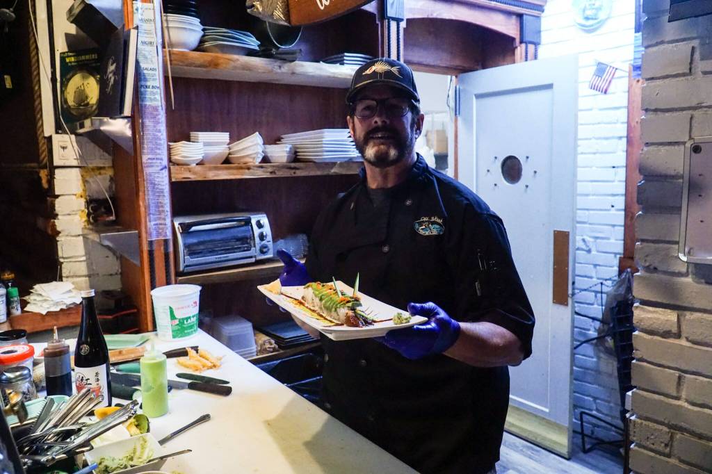 Photo by Sam Fletcher
Sushi chef Claude Johnston shows off the caterpillar roll in Off the Hook.