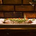 The caterpillar roll is part broiled eel sushi, part sculpture, with cucumber-sliver antennae, an avocado exoskeleton, tobiko or fish egg eyes and unagi sauce legs. (Photo by Sam Fletcher)