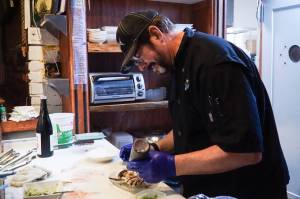 Photo by Sam Fletcher
Sushi chef Claude Johnston prepares the caterpillar roll in Off the Hook.