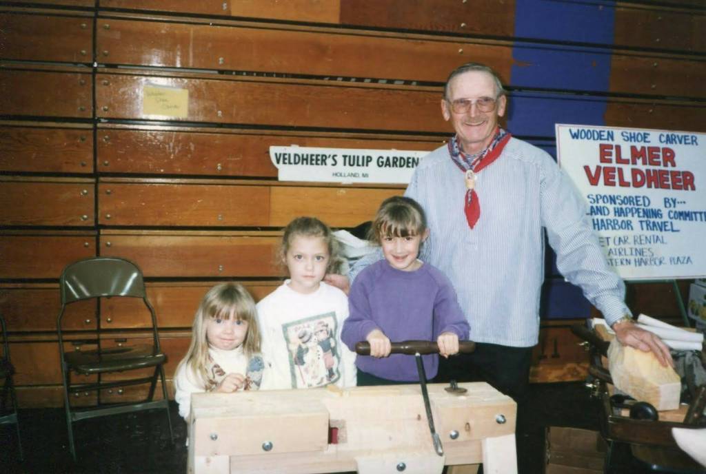 Photo provided
The Fakkema sisters pose with Elmer Veldheer, Oak Harbors klompen carver for over 20 years, in the 1990s. Rebecca Fakkema is on the right, next to Veldheer.