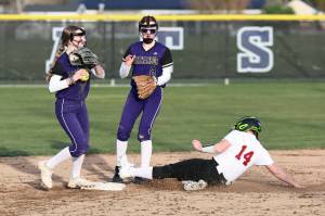 Photo by John Fisken
Shortstop Haylee Burleigh helps get a Cascade runner out during a game March 12 at Oak Harbor High School. Also helping is Mia Regan.