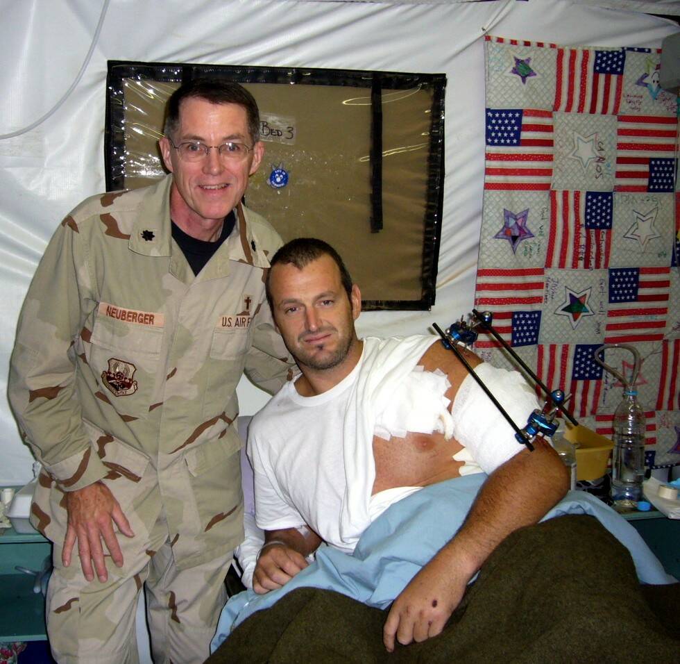 Chaplain, Lt Col, USAF (Ret) Jeffrey Neuberger stands with a wounded soldier, Gareth Evans, in Iraq. (Photo courtesy of Jeffrey Neuberger)