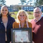 Aimee Bishop, center, smiles with her award next to WEA Vice President Janie White and President Larry Delaney. (Photo provided)