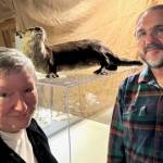Dalva Church and Rick Castellano stand with an otter.
