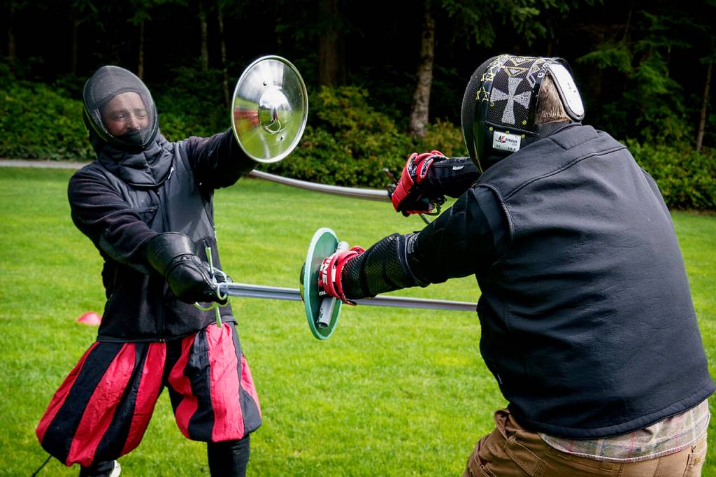 Freeland resident Ryan Vogt, left, spars with Nathan Habecker from the Snohomish Dueling Society. Vogt recently started the Whidbey Swordplay Association. (Photo by David Welton)
