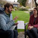 Astrologer Graham Gori tells reporter Kira Erickson about the intricacies of her birth chart. (Photo by David Welton)