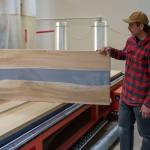 Maverick Christensen displays a table top made with wood and epoxy. (Photo by David Welton)