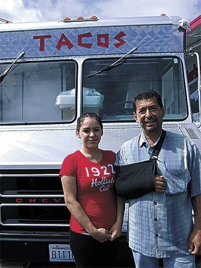 Eli Loera Sr., at right, and his daughter Brenda Loera stand in front of Jumbo Burritos original taco truck in 2013.