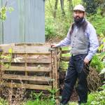 Derek Hoshiko stands by the two-bin compost in his backyard. Composting food waste at home can help reduce the greenhouse gases emitted from landfills and trash incinerators while producing healthy soil for the garden. (Photo by Luisa Loi)