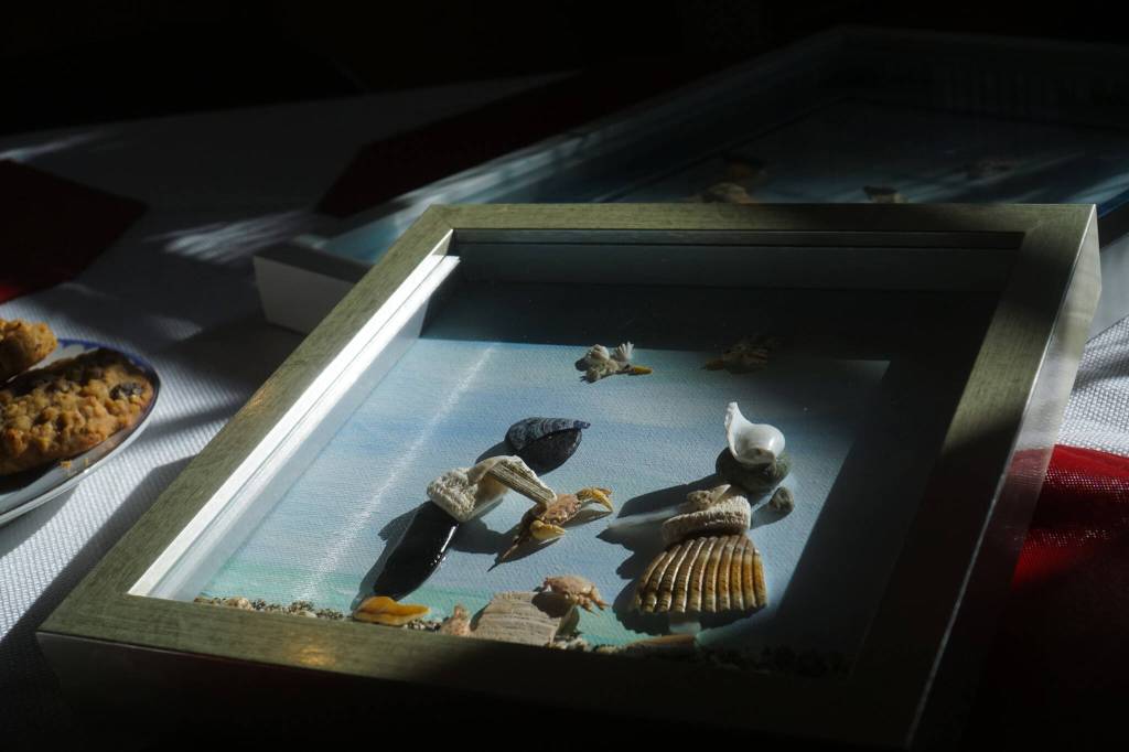 Made entirely of shells, rocks, odds and ends from the beach, Hammers work portrays wholesome scenes of sisters playing, fishermen and families interacting with Whidbeys scenery. (Photo by Sam Fletcher)