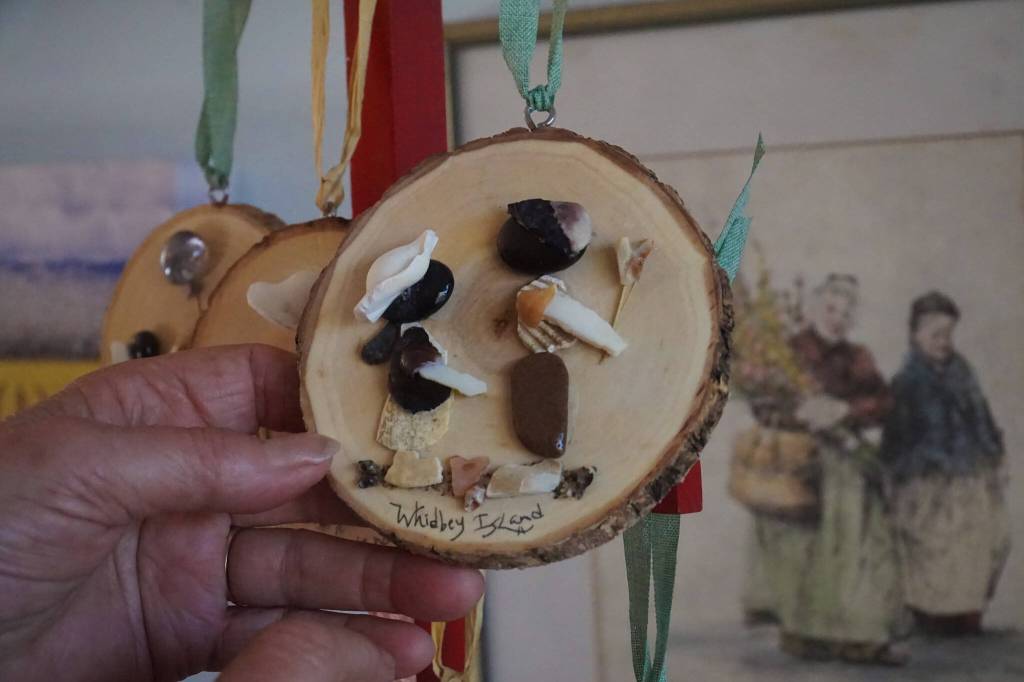Made entirely of shells, rocks, odds and ends from the beach, Hammers work portrays wholesome scenes of sisters playing, fishermen and families interacting with Whidbeys scenery. (Photo by Sam Fletcher)