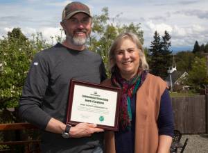 USDA photo by Phil Eggman
Arndt Property Management owner Damon Arndt is presented with the USDA Rural Developments Environmental Stewardship Award of Excellence by State Director Helen Price Johnson for his companys use of renewable energy at their business in Langley.